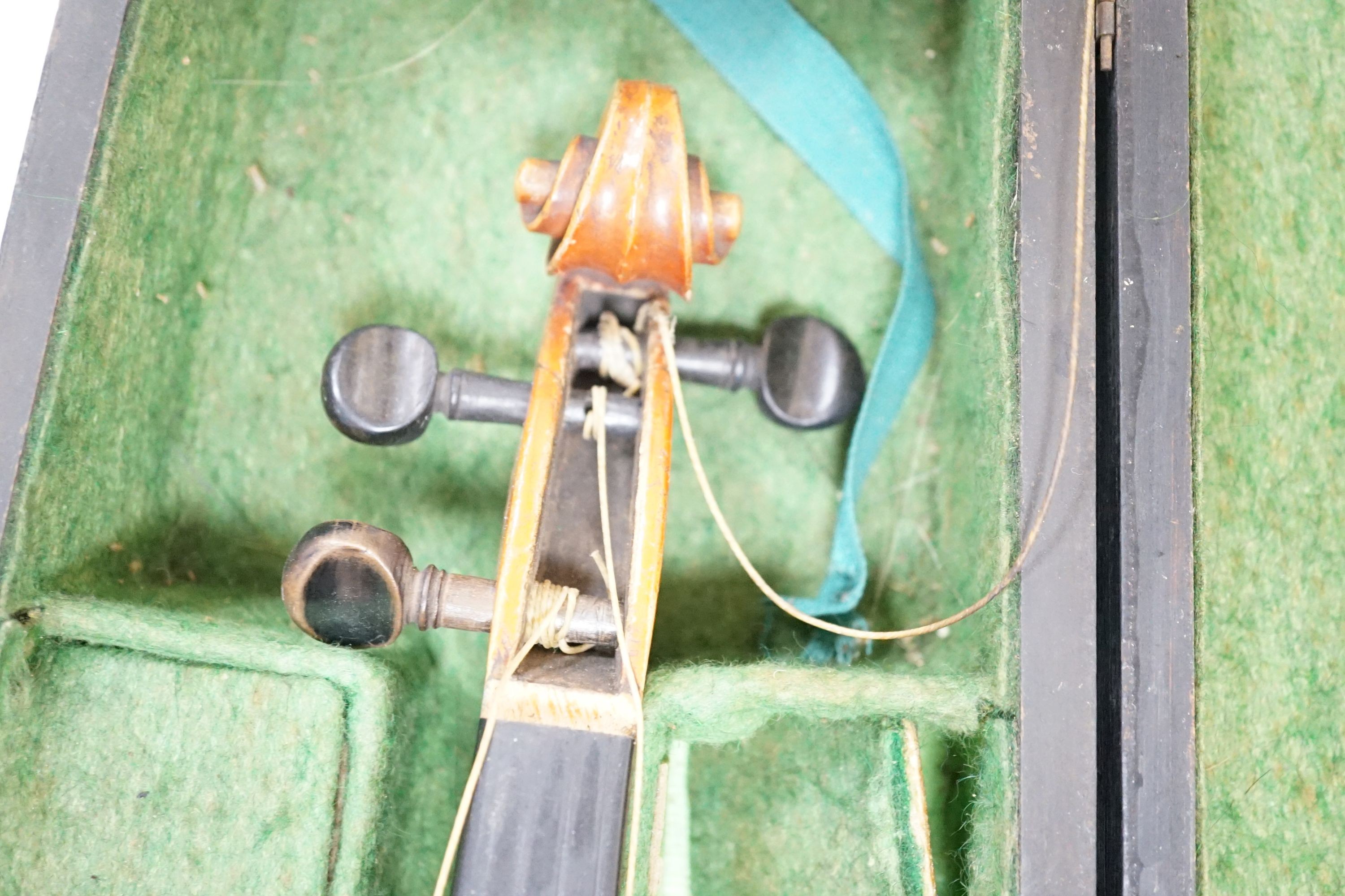 A 19th century 3/4 size violin, cased with 2 bows and 1 other German violin